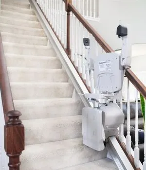 Elan straight indoor stairlift folded at the bottom of the steps