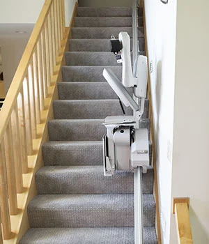 Elite straight indoor stair lift folded up to save staircase space