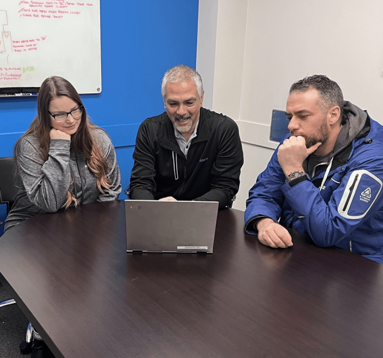 Home2stay team reviewing an accessible bathroom plan at a boardroom table