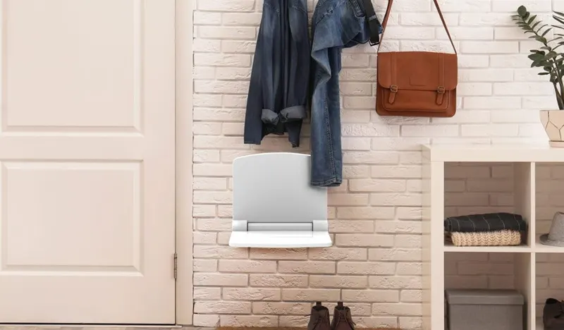 White folding shower seat in the open position