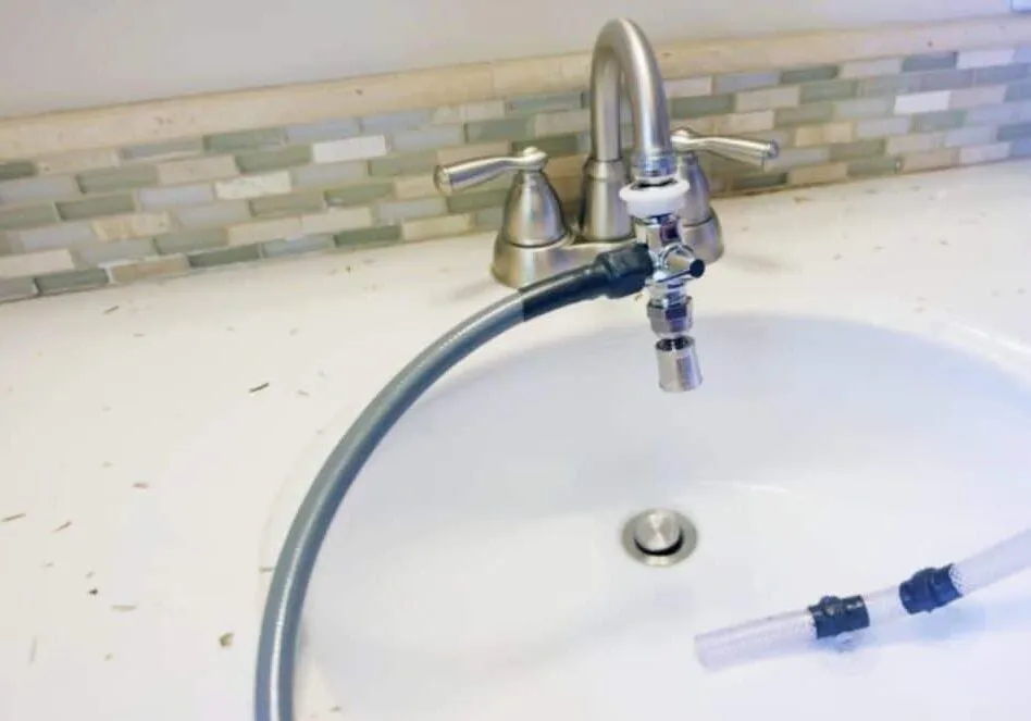 Quick-connect water supply hose attached smoothly to a standard household faucet