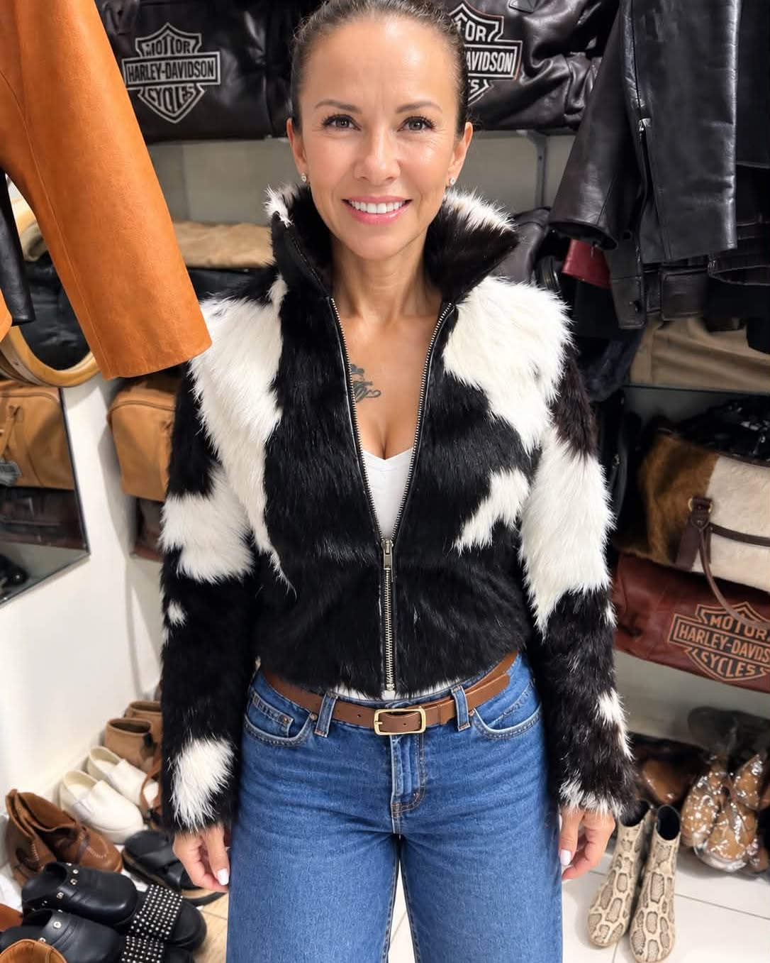 Woman wearing a black and white fur leather jacket in the atelier